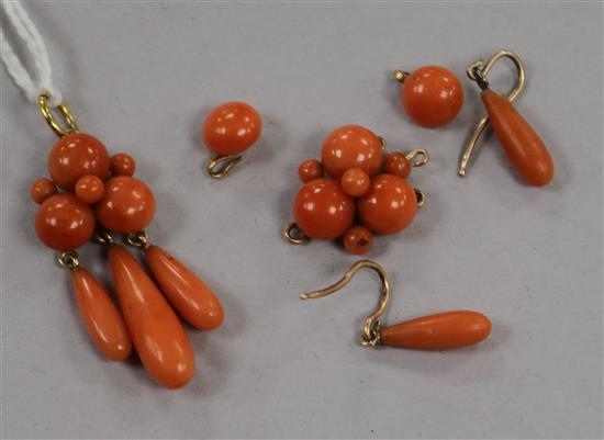 A yellow metal and coral drop pendant, a pair of coral earrings and another coral pendant,